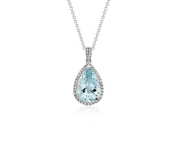 A shimmering statement in a lovely blue hue, this gemstone and diamond pendant features a light blue pear shape aquamarine framed with a halo of round brilliant diamonds set in 14k white gold with a matching cable chain necklace.