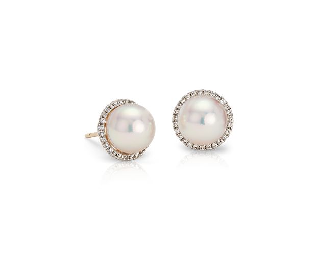 With a flash of brilliance, these Akoya cultured pearl and diamond earrings take classic up a notch. Two lustrous white pearls are surrounded by a subtly glittering halo of round diamonds set in polished 14k yellow gold for a look that's both easy and elegant.