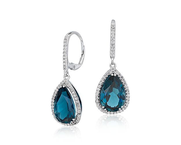 For your, "something blue," or a dramatic everyday pop of color, a pair of London blue topaz gemstones shimmer like the deep sea in these timeless drop earrings. A subtle but sparkling halo of transparent white topaz adds a refined finish.
