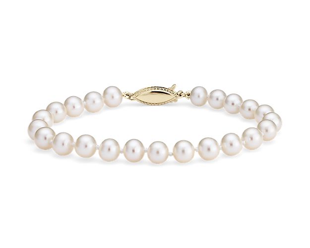 Nearly round, these freshwater cultured pearls are strung securely on a 8" hand-knotted silk blend cord and secured with a 14k yellow gold safety clasp.