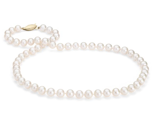 Our classic pearl strand features nearly round freshwater cultured pearls strung on a 20" hand-knotted silk blend cord. This strand is finished with a secure safety clasp in 14k yellow gold.