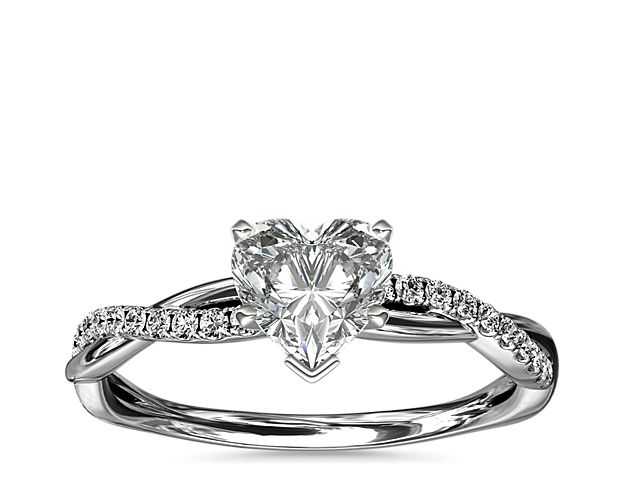 Classic with a twist, this platinum engagement ring features a delicate twist of pavé-set diamonds that will complement the center diamond of your choice.