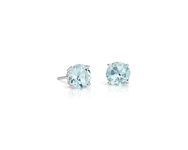 Simply elegant, these aquamarine stud earrings feature hand-selected cool blue aquamarines set in 14k white gold four-prong settings.