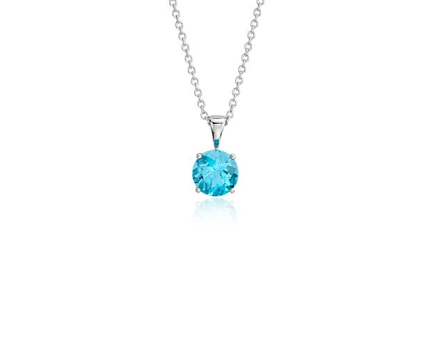 Vibrant and colorful, this gemstone pendant features an electric blue topaz set in a 14k white gold four-prong setting suspended from a dainty 18-inch cable chain. A classic piece of everyday luxury and the birthstone for December.