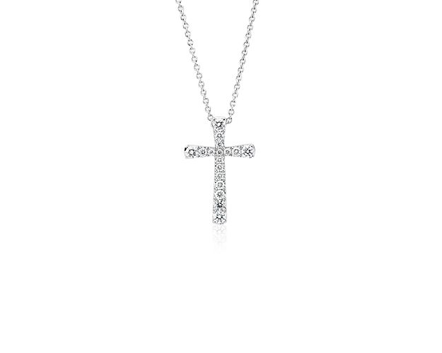 Beautifully crafted, this petite diamond pendant features round diamonds set in a dainty cross design of 14k white gold with a matching 18 inch cable chain necklace.