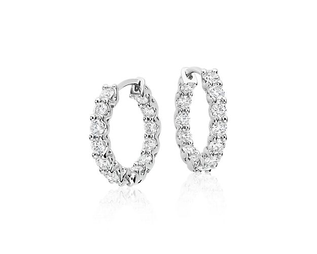 Take your style up a notch with the natural decadence of these 18k white gold hoop earrings, showcasing 1 3/4 carats of round diamonds intricately arranged in an eternity-inspired design. Diameter of hoop measures 5/8 Inch.