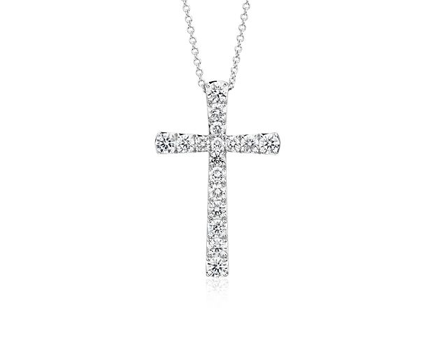 Seventeen brilliant pave-set round diamonds make up this beautiful cross pendant crafted in 14k white gold.
