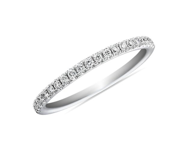 A row of pavé-set sparkling round brilliant diamonds shimmer brightly in this platinum ring she'll treasure as a wedding or anniversary band.