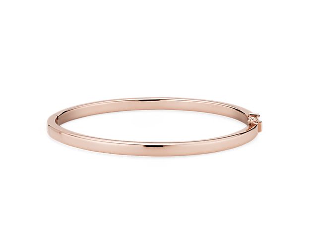 Go for a bold and bright look with this Italian crafted squared hinged bangle bracelet. Crafted in brightly polished 14k rose gold, this bracelet is lightweight yet looks substantial. A statement piece on its own, or stack with other bracelets for an on-trend look.