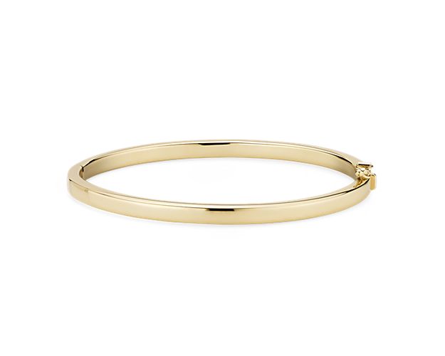 Go for a bold and bright look with this Italian crafted squared hinged bangle bracelet. Crafted in brightly polished 14k yellow gold, this bracelet is lightweight yet looks substantial. A statement piece on its own, or stack with other bracelets for an on-trend look.