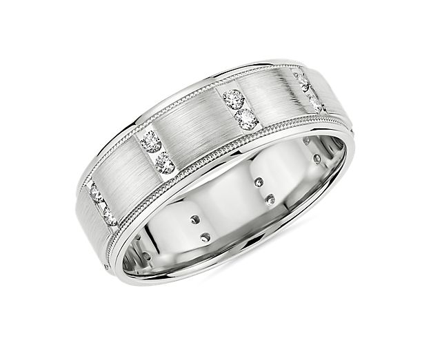This gleaming platinum eternity band promises a sleek look that is elegantly timeless and comfortable to wear everyday. Vertical rows of diamonds lend eye-catching sparkle along the band.