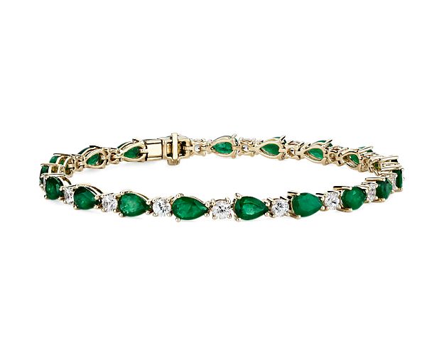 Captivating in color, this bracelet features vibrant emerald gemstones accented with sparkling round white sapphires framed in 14k yellow gold.