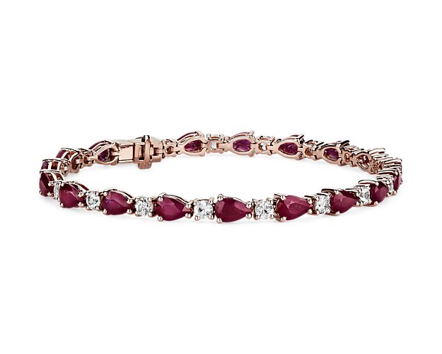 Captivating in color, this bracelet features vibrant ruby gemstones accented with sparkling round white sapphires framed in 14k rose gold.