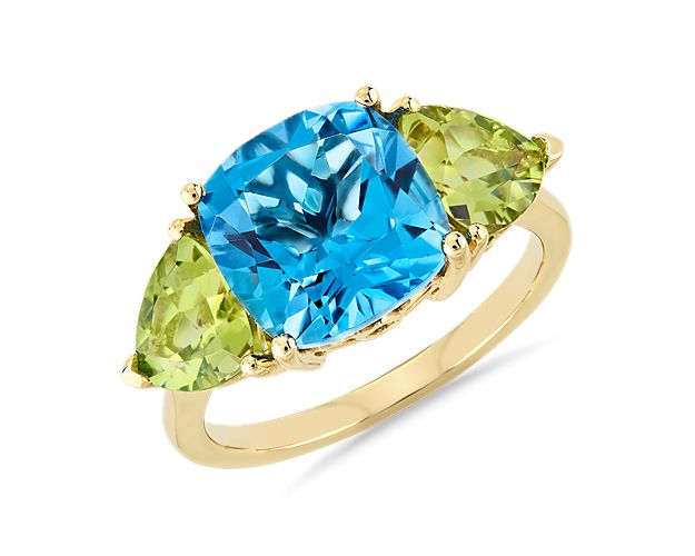 You'll love the interplay of colors between the Swiss blue topaz and peridot stones in this eye-catching ring. This chic ring features two trillion stones and one center cushion stone to show off the brilliant colors.