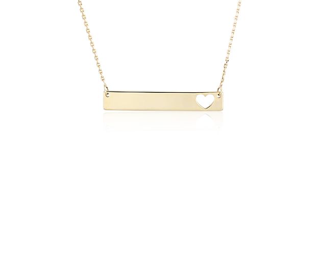 This necklace adds a little touch of love to your look with a sleek 14k yellow gold bar featuring a heart-shaped cutout worn on a delicate chain.  Engraving is available with the heart shape shown on the left side only.