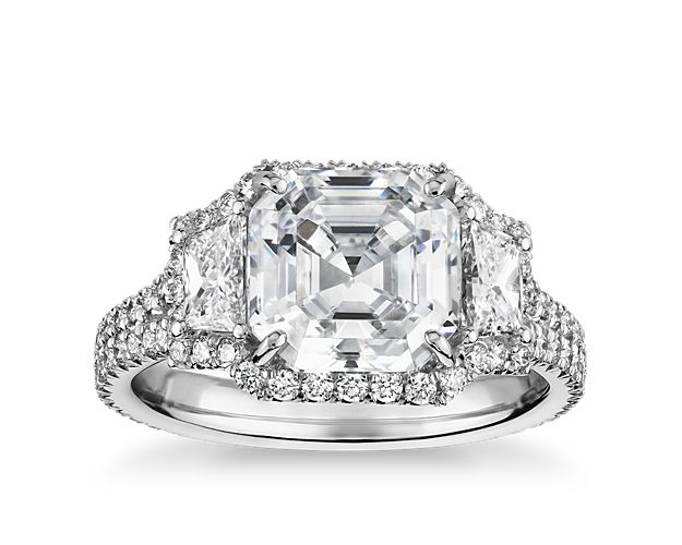 Showcase the breathtaking Asscher-cut diamond of your choice in this shining platinum engagement ring, flanked with dazzling trapezoid diamonds and enlivened with a brilliant pavé halo.