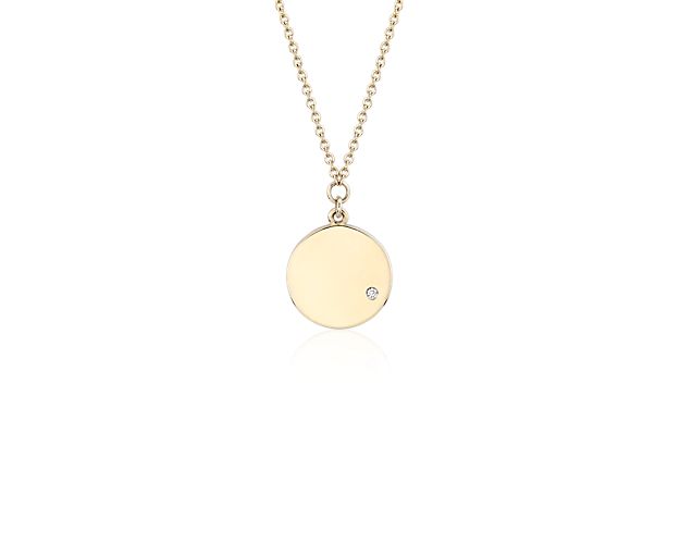This mini 14k yellow gold disc features a petite offset diamond and a coordinating cable chain that can be worn at 16 or 18 inches for versatility.