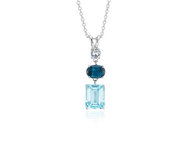 Showcasing a column of emerald-cut blue topaz, round white sapphire, and oval London blue topaz, this sterling silver pendant finishes any look with light-catching color.