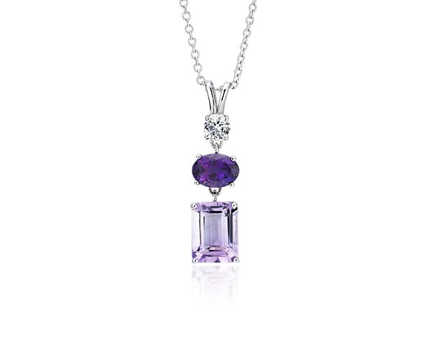 Showcasing a column of two different shades of amethyst and a white sapphire, this sterling silver pendant finishes any look with light-catching color.