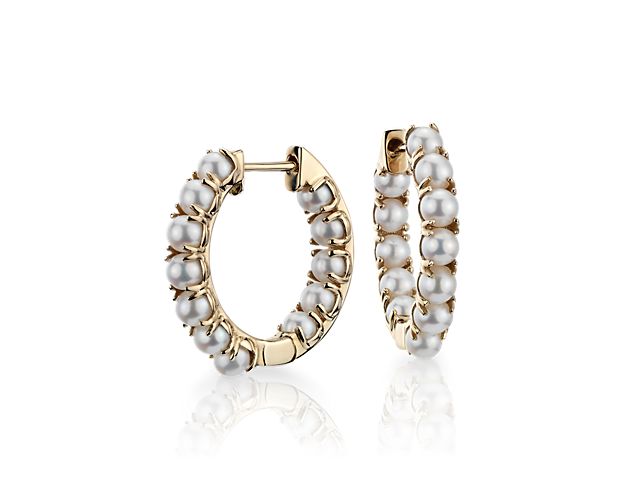 A modern twist on classic glamour, a row of lustrous Freshwater pearls line the inner and outer sides of these 14k yellow gold earrings giving the appearance of one continuous line.
