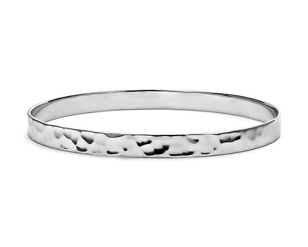 Organically elegant, this sterling silver bangle bracelet is timeless and beautifully finished with a hammered texture. Perfect alone or stacked with other bracelets for an on-trend look.
