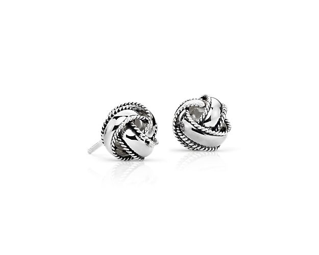 Dimensional and modern, these stud earrings are intricately crafted in hollow sterling silver with textural accents.