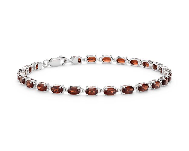Truly bright and festive, this gemstone bracelet features vibrant garnet gemstones framed in a delicate sterling silver setting.