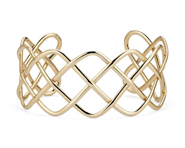 A bold statement, this Italian crafted wide braided cuff bracelet is sure to steal the show. Forged of 14k yellow gold, it's the perfect accessory.
