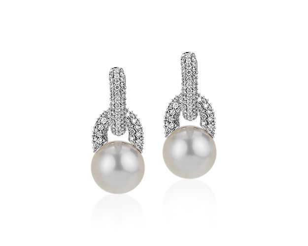 Make a statement with these striking South Sea cultured pearl earrings that suspend from diamond encrusted hoops and are set in 18k white gold. These earrings can also be worn as diamond hoops without the pearl for added versatility.