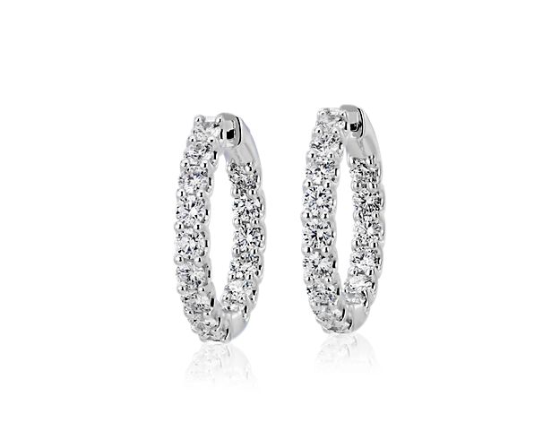 A continuous band of brilliance. These diamond hoop earrings feature 32 diamonds for a total weight of three carats, prong-set in 18k white gold. Diameter of hoop measures 7/8 Inch.