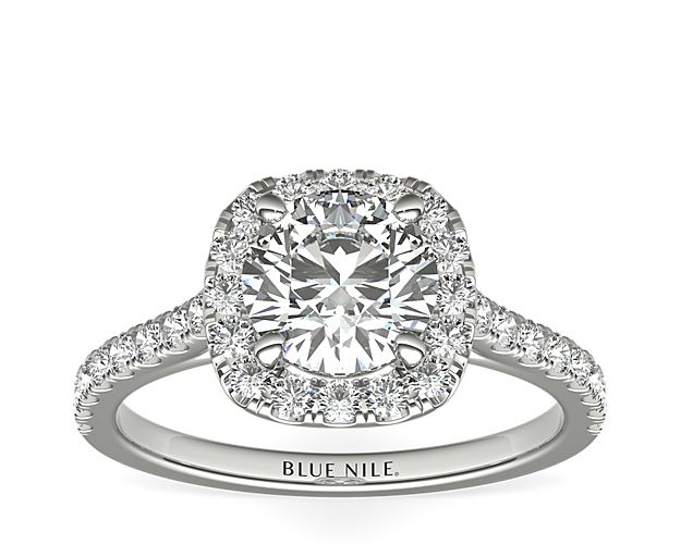Delicate in design, this diamond engagement ring showcases a cushion halo of pavé-set diamonds to frame the diamond of your choice set in enduring 14k white gold.