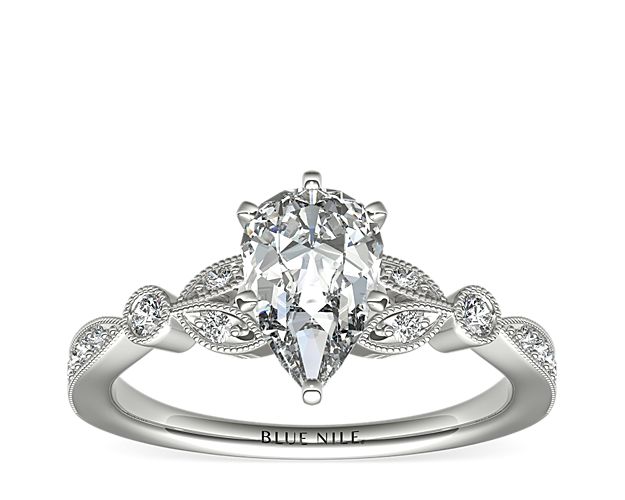 Vintage-inspired, this delicate 14k white gold engagement ring features pavé-set round diamonds surrounded by a milgrain edge.