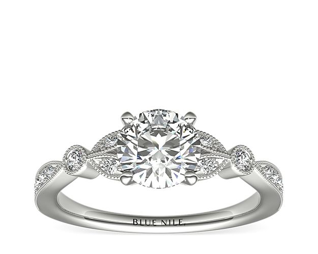 Vintage-inspired, this delicate 14k white gold engagement ring features pavé-set round diamonds surrounded by a milgrain edge.