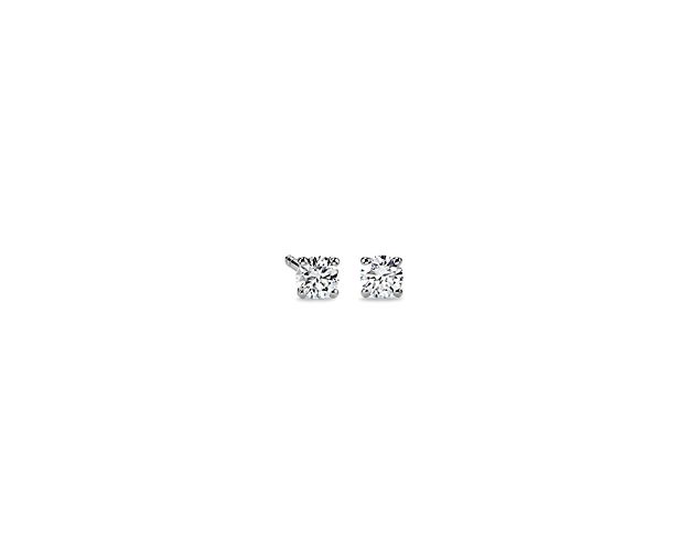 Beautifully matched, these diamond stud earrings feature round, near-colorless diamonds set in 14k white gold four-prong settings with double-notched friction backs.