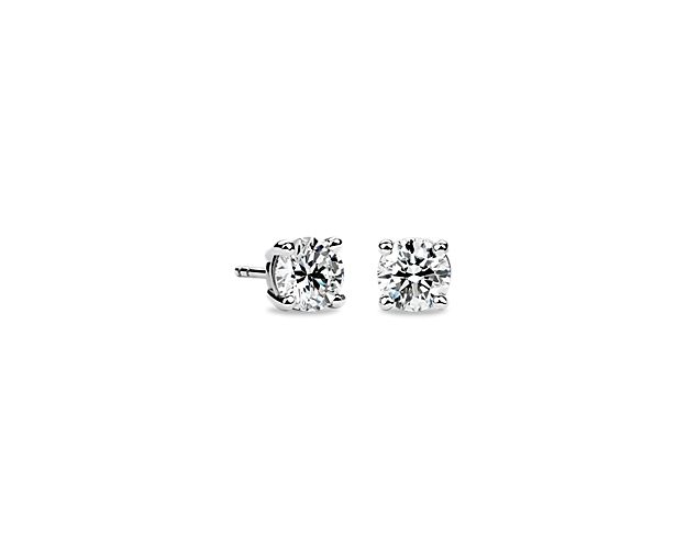 Beautifully matched, these diamond stud earrings feature round, near-colorless diamonds set in 14k white gold four-prong settings with guardian backs and posts.