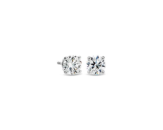 Beautifully matched, these diamond stud earrings feature round, near-colorless diamonds set in 14k white gold four-prong settings with guardian backs and posts.