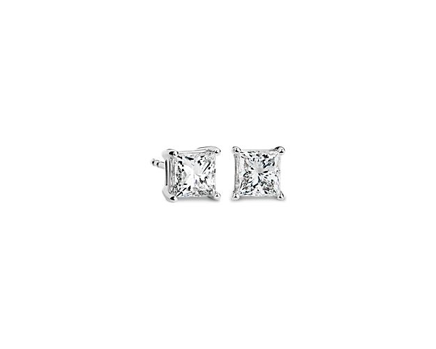 Brilliance is captured in these diamond stud earrings showcasing princess cut diamonds in four-prong settings of 14k white gold with guardian backs and posts. The pair amounts to a 2 carat total diamond weight.