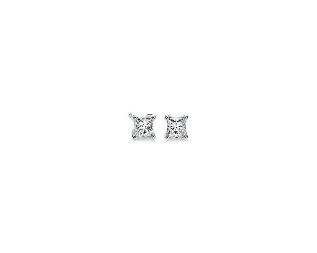 A matched pair of princess-cut diamonds are held by platinum prongs. Earrings are finished with double-notch friction backs for pierced ears. Each earring weighs roughly 1/6 carat, for a total diamond weight of 1/3 carat.