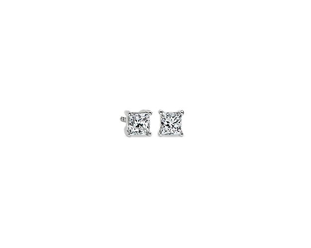 A matched pair of princess-cut diamonds are held by platinum prongs. Earrings are finished with double-notched friction backs for pierced ears. Each earring weighs roughly 3/8 carat, for a total weight of 3/4 carat.