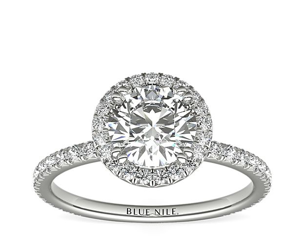 Beautifully crafted, this Blue Nile Studio platinum engagement ring features a french pavé-set diamond halo that encompasses the center diamond of your choice.