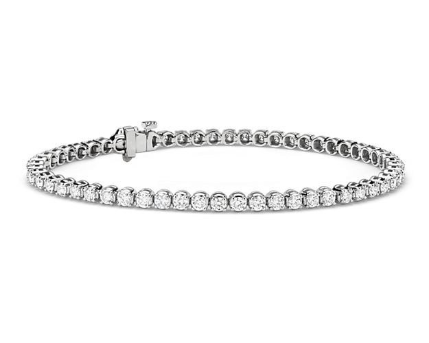 Brilliance defined, this diamond tennis bracelet features brilliant cut round diamonds set in a four-prong straight line design of 14k white gold.