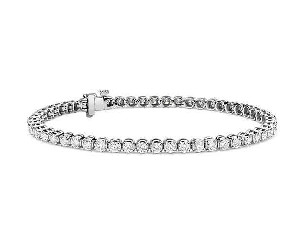 Flash some brilliance with this breathtaking tennis bracelet, showcasing dazzling round diamonds prong-set in complementing 14k white gold.
