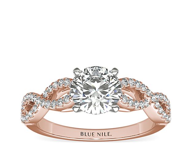 Beautiful and delicate, this engagement ring is designed with two intertwined rose gold bands of micropavé set diamonds to frame your center diamond.