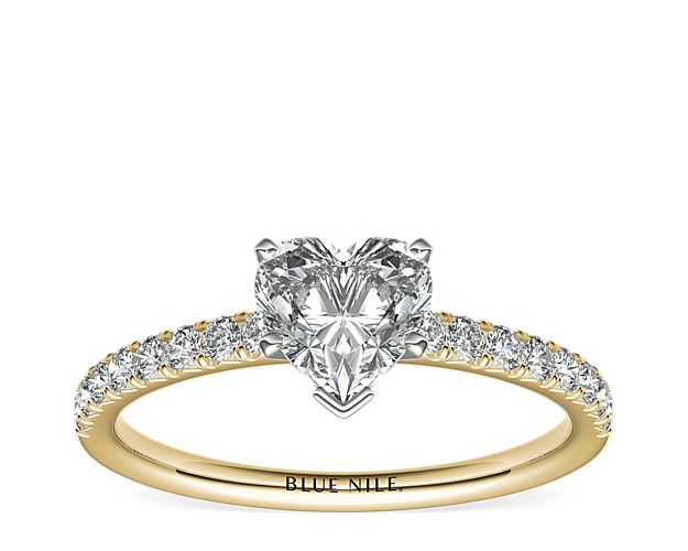 With the perfect hint of gold, this engagement ring showcases French pavé-set diamonds set in 14k yellow gold that complement your choice of center diamond.