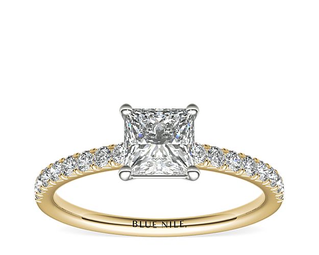 With the perfect hint of gold, this engagement ring showcases French pavé-set diamonds set in 14k yellow gold that complement your choice of center diamond.
