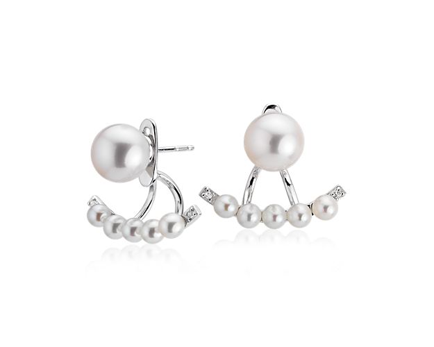 These freshwater cultured pearl earrings set in sterling silver feature a lower smile jacket studded with additional pearls and white topaz gemstone accents for an elegant look, but with a creative flourish. The lower smile jacket is removable so they can also be worn as single-pearl studs for added versatility.