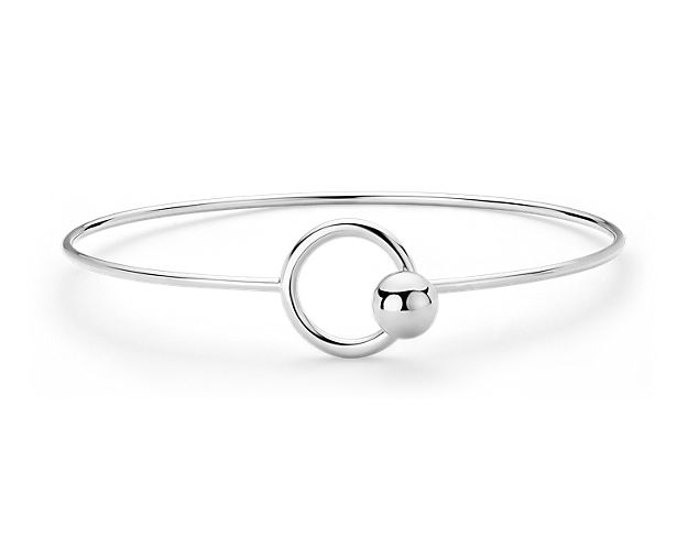 Crafted with sterling silver, this bangle bracelet can be worn open or fastened by looping the bead hook clasp through the ring.