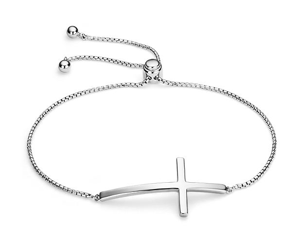 Wear your modern style boldly and on a bolo-style bracelet. Elegant sterling silver presents a curved sideways cross for a flush and comfortable fit on your wrist. With box chain closure.