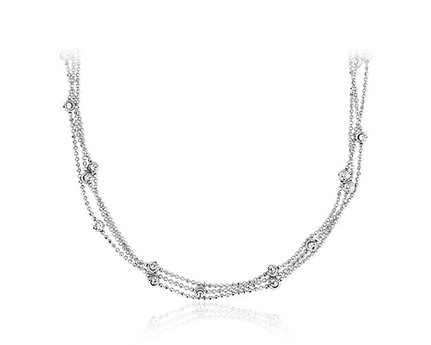 Get ready to shimmer when you wear this elegant choker-style moon-cut beaded necklace of bright, rhodium-coated sterling silver. The 13 inch bead cord stays on securely with a lobster claw clasp and can be adjusted up to 16 inches.