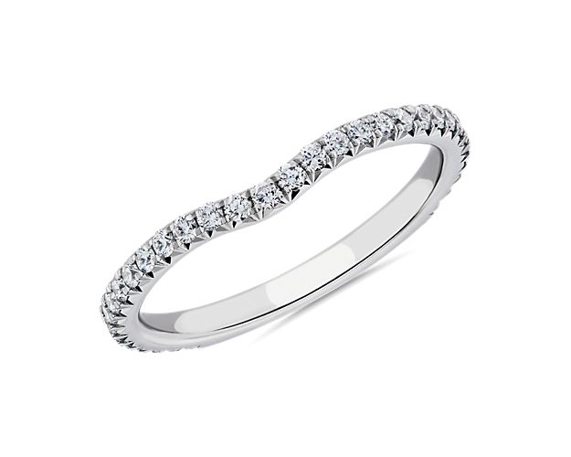 Every engagement ring deserves a fitting match. This beautifully crafted ring features a row of brilliant pavé diamonds that curves delicately around your center stone.